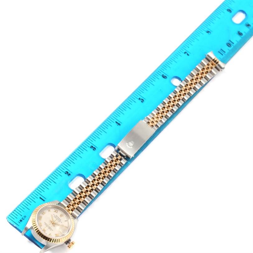 The image shows a Rolex Datejust 79173 Women's Stainless Steel Beige Dial 79173 Women's Stainless Steel Beige Dial watch laid flat along a blue measuring ruler, displaying the face and the two-tone metal bracelet.