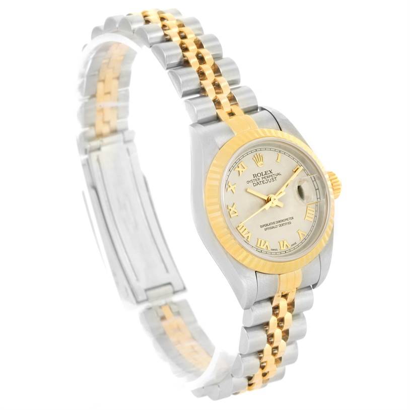 This image shows a side angle view of the Rolex Datejust 79173 Women's Stainless Steel Beige Dial 79173 Women's Stainless Steel Beige Dial watch, highlighting its two-tone bracelet, dial, and fluted bezel.