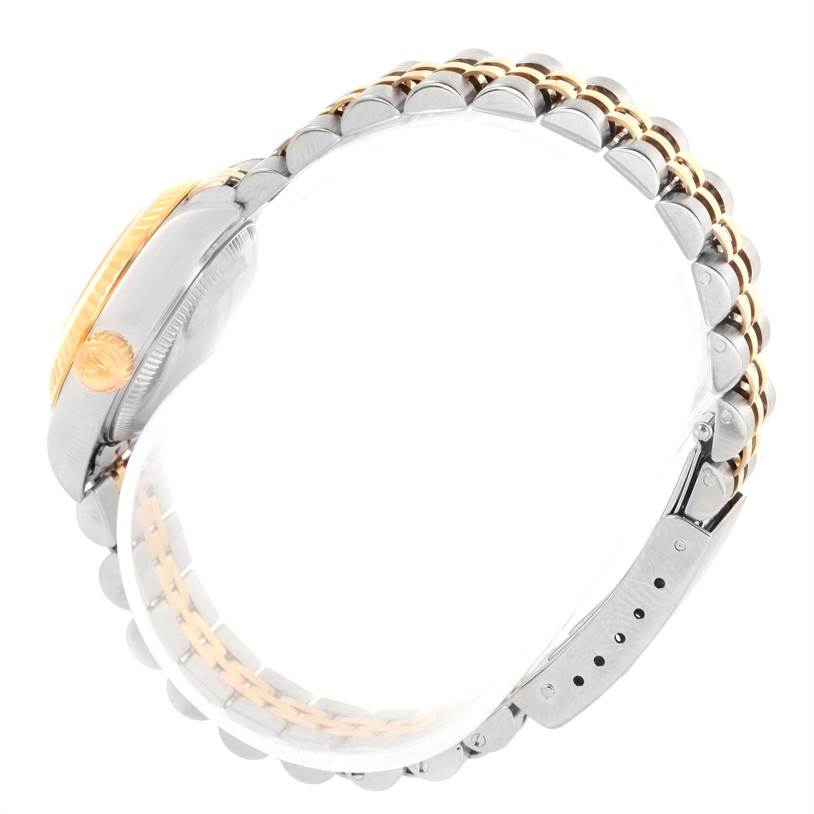 This Rolex Datejust 79173 Women's Stainless Steel Beige Dial 79173 Women's Stainless Steel Beige Dial watch is shown from a side angle, highlighting its two-tone bracelet and crown.