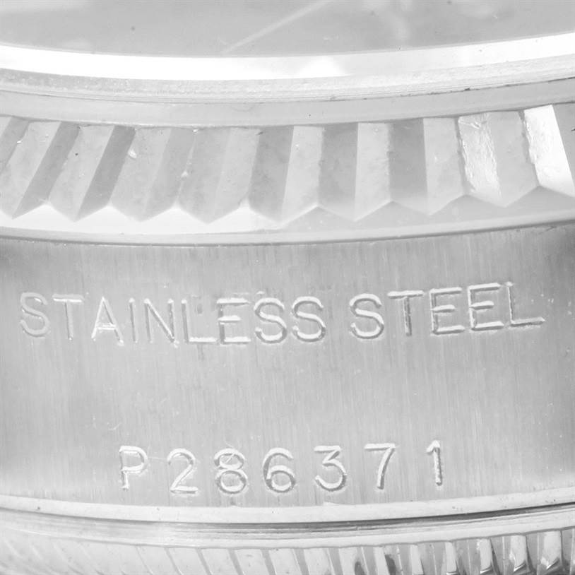 This close-up image shows the stainless steel casing and serial number of a Rolex Datejust 79174 Women's Stainless Steel Blue Dial 79174 Women's Stainless Steel Blue Dial watch.