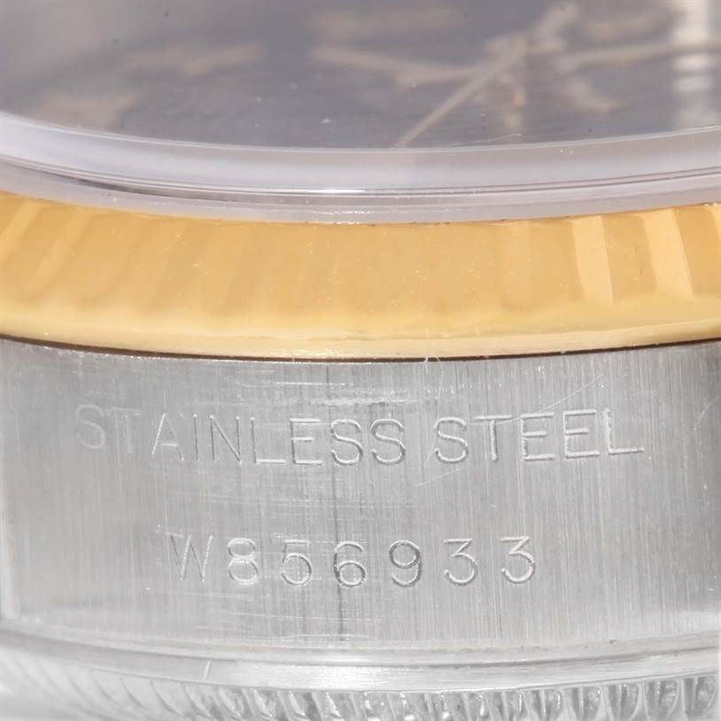 This close-up image of a Rolex Datejust 69173 Women
s Stainless Steel Black Dial 69173 Women
s Stainless Steel Black Dial watch shows part of its stainless steel case with a visible serial number.