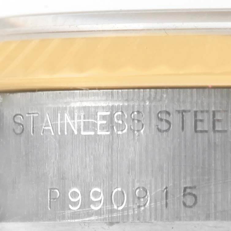 This close-up image of the Rolex Datejust 79173 Women's Stainless Steel White Dial 79173 Women's Stainless Steel White Dial shows the side of the watch case with engraved serial and "stainless steel" text.