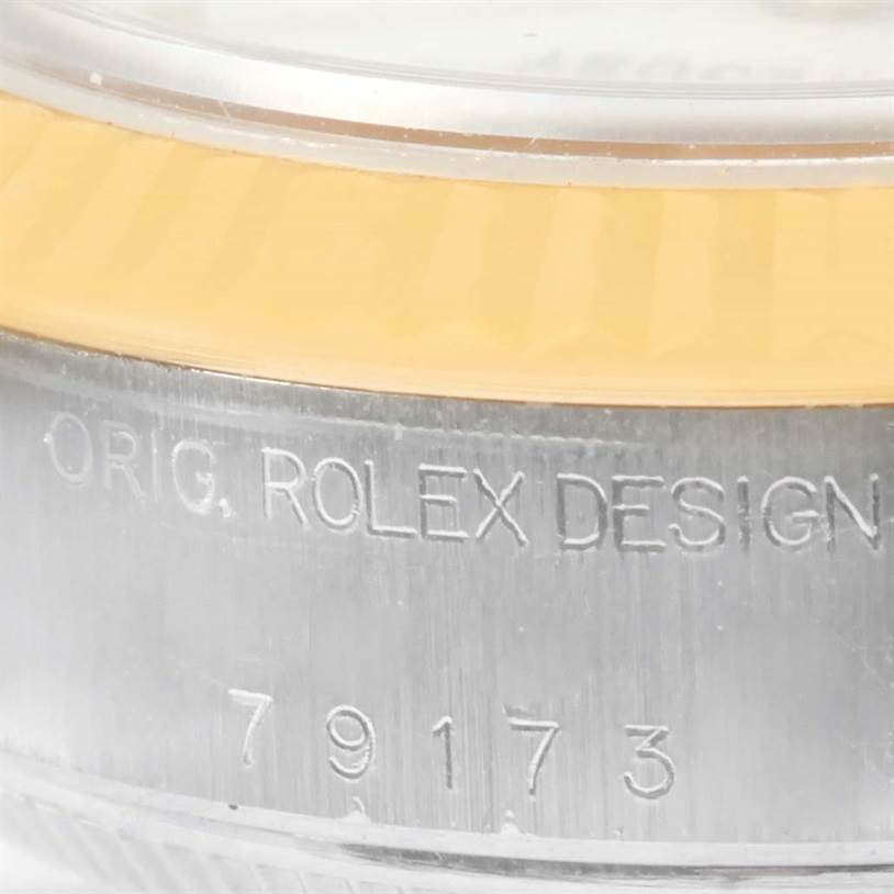 This close-up image shows the side of the Rolex Datejust 79173 Women's Stainless Steel White Dial 79173 Women's Stainless Steel White Dial watch case, highlighting part of its bezel and engraved model number.