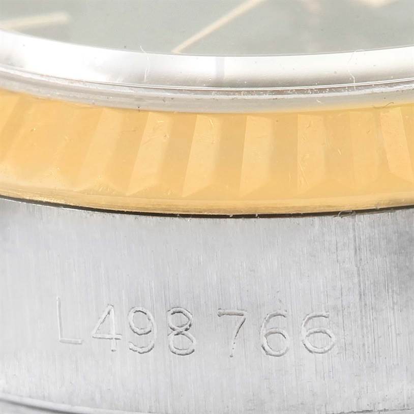 This close-up shows the side of a Rolex Datejust 69173 Women's Stainless Steel Black Dial 69173 Women's Stainless Steel Black Dial watch, highlighting the bezel and part of the case with its serial number.