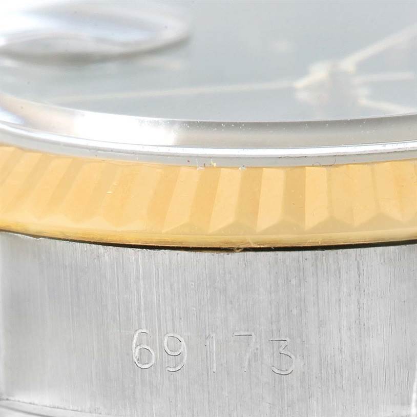 The image shows a close-up side view of the Rolex Datejust 69173 Women's Stainless Steel Black Dial 69173 Women's Stainless Steel Black Dial model 69173, highlighting the case and part of the fluted bezel.