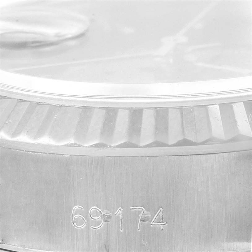 Close-up of the bezel and part of the case of a Rolex Datejust 69174 Women's Stainless Steel Black Dial 69174 Women's Stainless Steel Black Dial watch, showing the model number 69174.