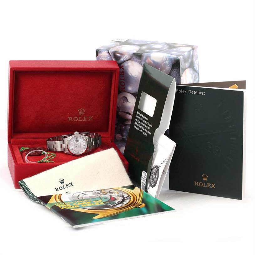 The image shows the Rolex Datejust 79174 Women's Stainless Steel Mother of Pearl Dial 79174 Women's Stainless Steel Mother of Pearl Dial watch with its box, warranty card, manuals, and other accessories.