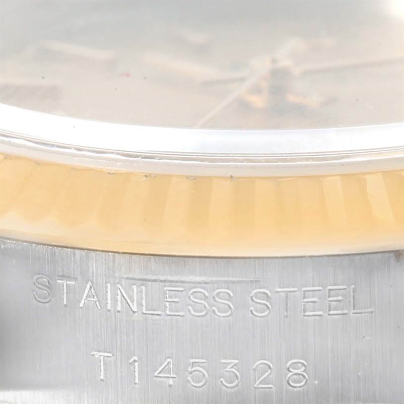 The image shows a close-up of the side of a Rolex Datejust 69173 Women
s Stainless Steel Champagne Dial 69173 Women
s Stainless Steel Champagne Dial watch, focusing on the stainless steel case back and part of the bezel.