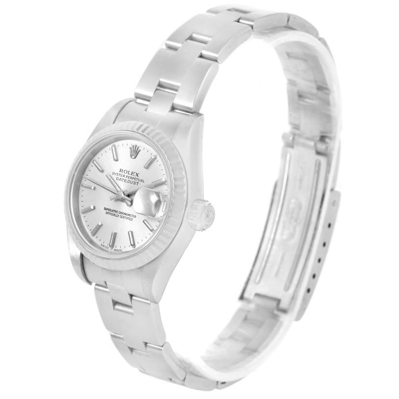 The image shows a Rolex Datejust 79174 Women
s Stainless Steel Silver Dial 79174 Women
s Stainless Steel Silver Dial watch from a three-quarter side angle, featuring the dial, bezel, and bracelet.