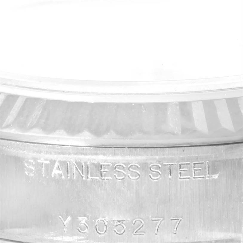 This image shows a close-up of the side of a Rolex Datejust 79174 Women
s Stainless Steel Silver Dial 79174 Women
s Stainless Steel Silver Dial watch, highlighting the stainless steel engraving and part of the serial number.