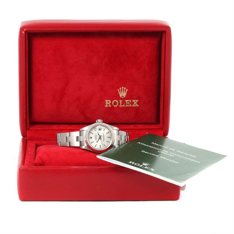 The Rolex Datejust 79174 Women
s Stainless Steel Silver Dial 79174 Women
s Stainless Steel Silver Dial watch is displayed in an open red box, showcasing its face and bracelet, accompanied by documentation.