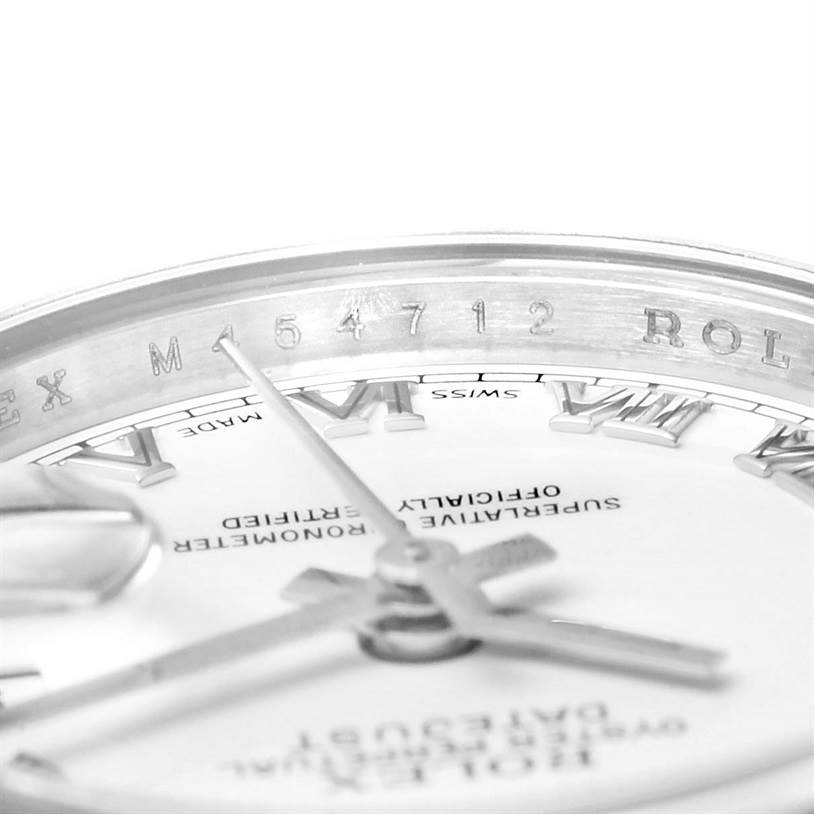 This close-up angle of the Rolex Datejust 179174 Women
s Stainless Steel White Dial 179174 Women
s Stainless Steel White Dial watch shows the dial, hands, and part of the rehaut with the engraved serial number.