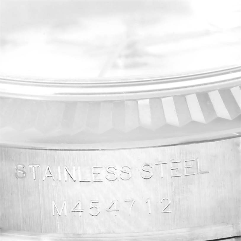This image shows a close-up of the stainless steel side case with engravings on a Rolex Datejust 179174 Women
s Stainless Steel White Dial 179174 Women
s Stainless Steel White Dial watch.