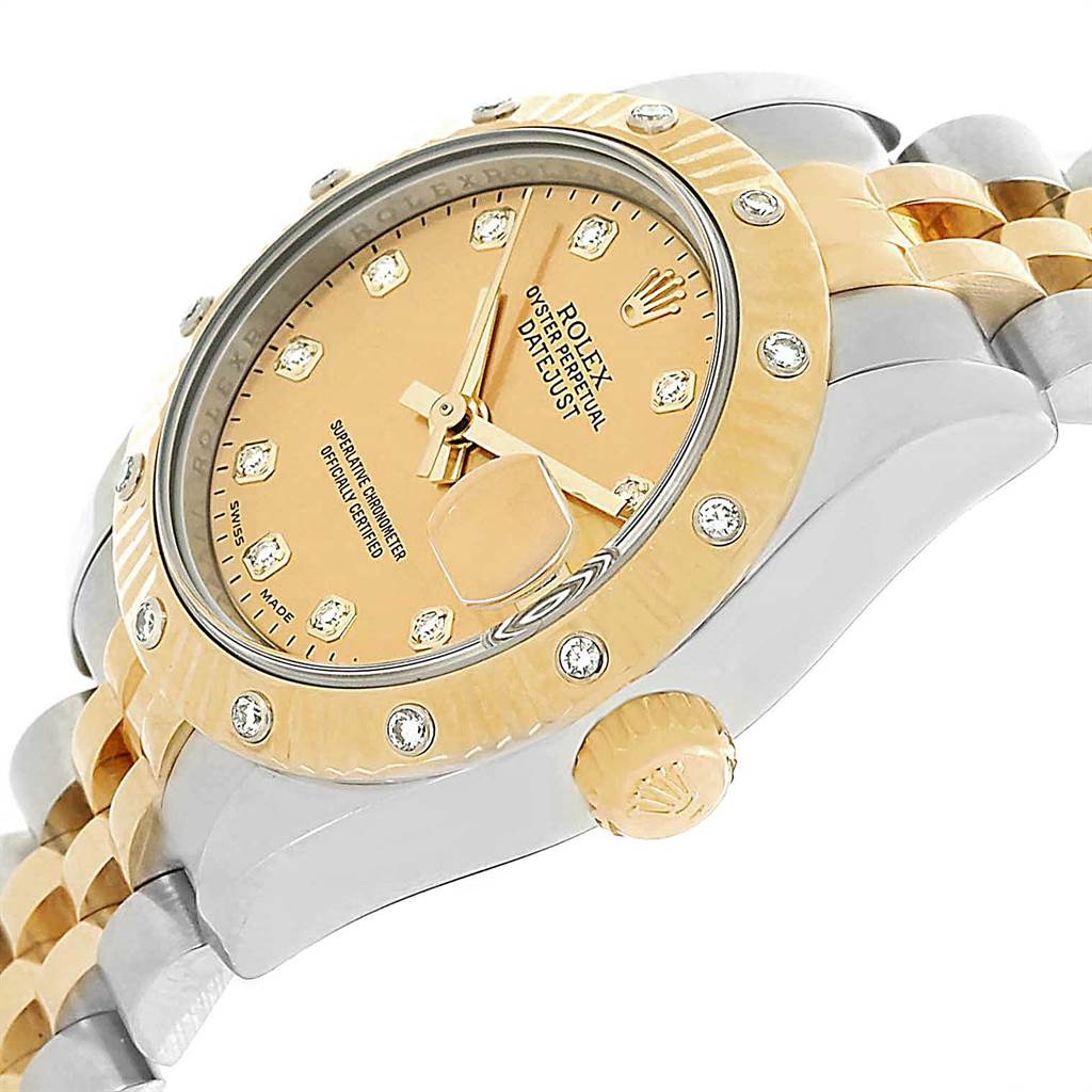 This side-angle view of the Rolex Datejust 179313 Women's Stainless Steel Champagne Dial 179313 Women's Stainless Steel Champagne Dial watch shows its crown, bezel, dial, and part of the bracelet.