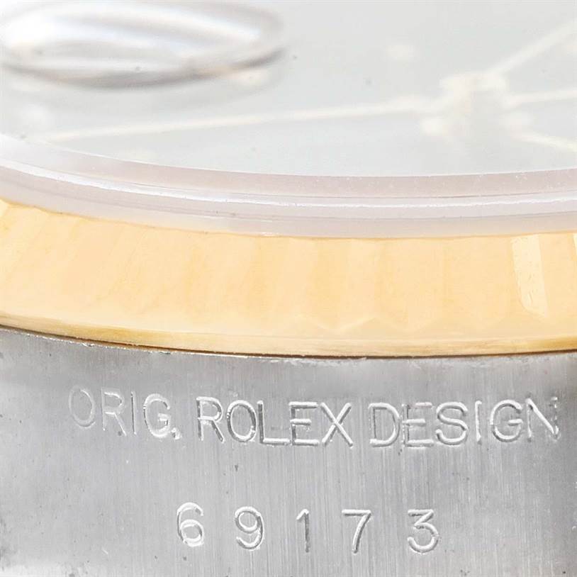 Close-up of the side view of a Rolex Datejust 69173 Women's Stainless Steel Blue Dial 69173 Women's Stainless Steel Blue Dial, showing the inscription "Orig. Rolex Design 69173" on the case.