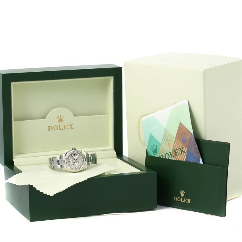 The image shows a Rolex Datejust 179174 Women's Stainless Steel Mother of Pearl Dial 179174 Women's Stainless Steel Mother of Pearl Dial watch in its box, along with manuals and protective cloth.