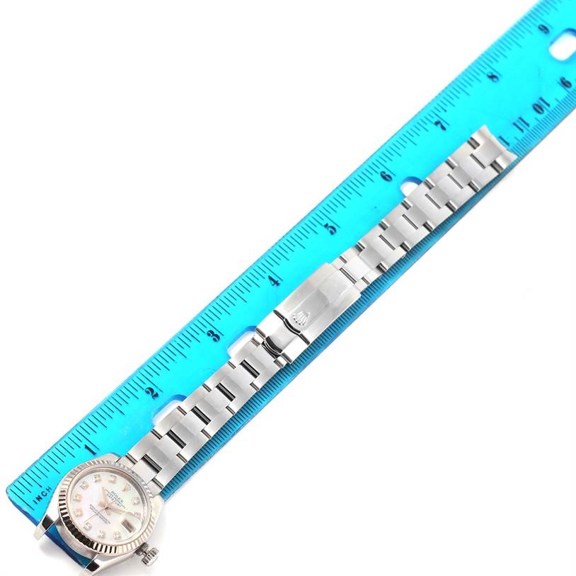 The image shows a Rolex Datejust 179174 Women's Stainless Steel Mother of Pearl Dial 179174 Women's Stainless Steel Mother of Pearl Dial watch laid flat with a blue ruler measuring its length.