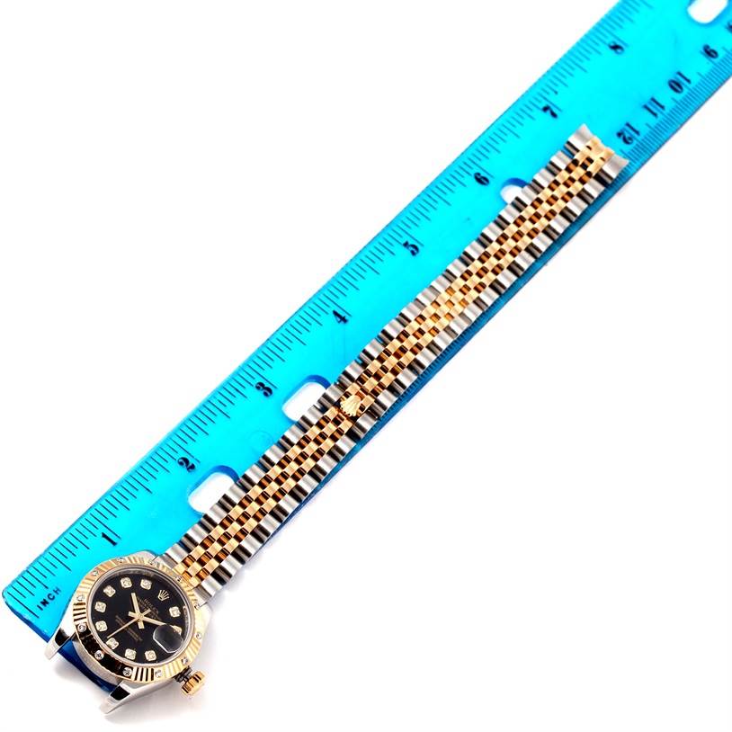 The Rolex Datejust 179313 Women's Black Dial 179313 Women's Black Dial watch is shown from the top, with a ruler measuring its bracelet and part of the watch face.