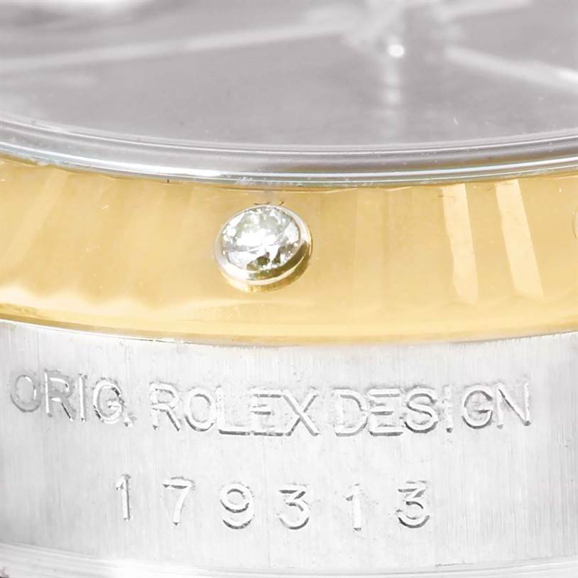 The image shows a close-up of the bezel and side of a Rolex Datejust 179313 Women's Black Dial 179313 Women's Black Dial watch, with a diamond marker and engraved text "ORIG. ROLEX DESIGN" and model number "179313".