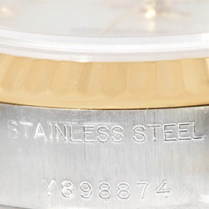 This close-up angle shows the side of a Rolex Datejust 79173 Women
s Stainless Steel Mother of Pearl Dial 79173 Women
s Stainless Steel Mother of Pearl Dial watch, highlighting the "STAINLESS STEEL" engraving and serial number.