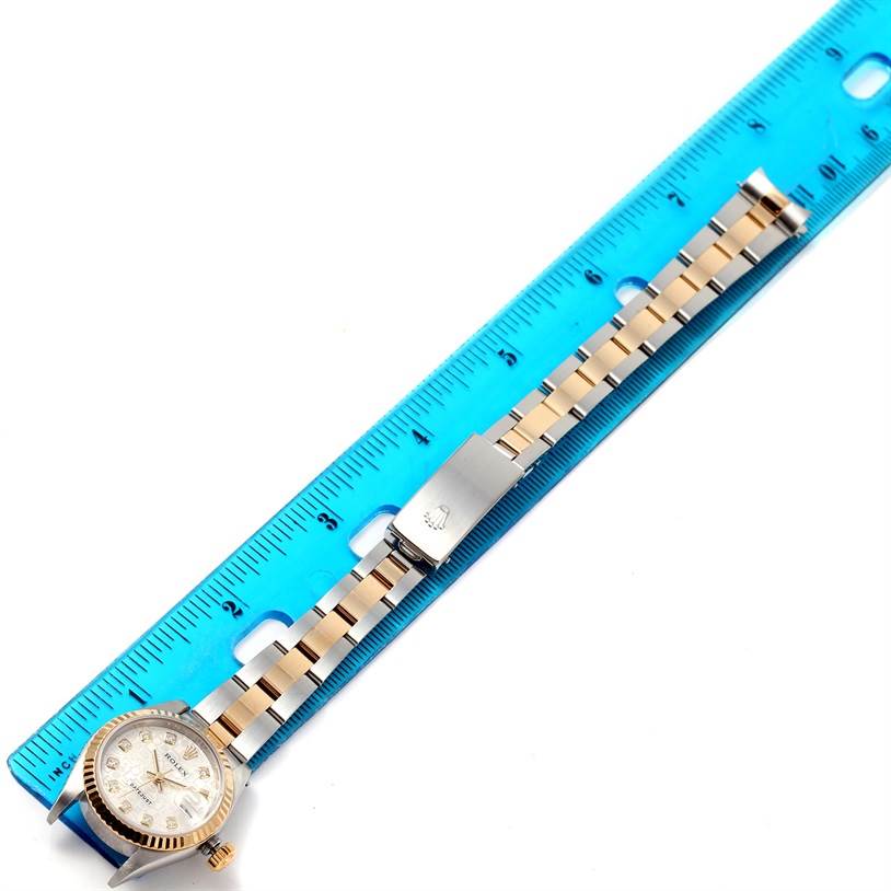 The image shows a Rolex Datejust 79173 Women's Stainless Steel Silver Dial 79173 Women's Stainless Steel Silver Dial watch laid flat beside a blue ruler, displaying the dial, case, and bracelet.