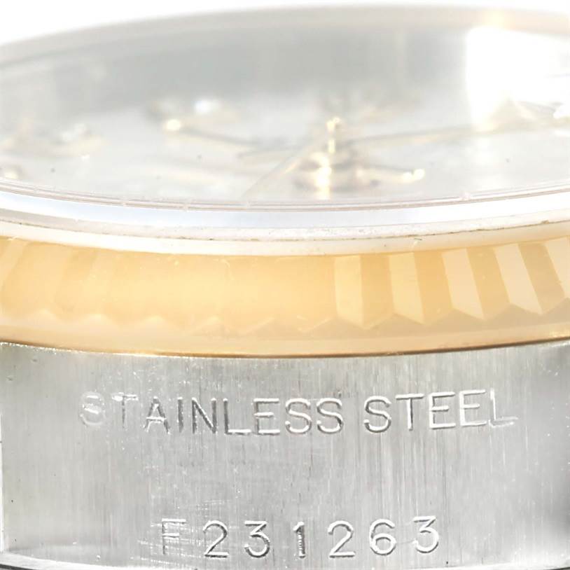 This close-up image of a Rolex Datejust 79173 Women's Stainless Steel Silver Dial 79173 Women's Stainless Steel Silver Dial watch showcases the bezel, crystal, and part of the case with engraved details.