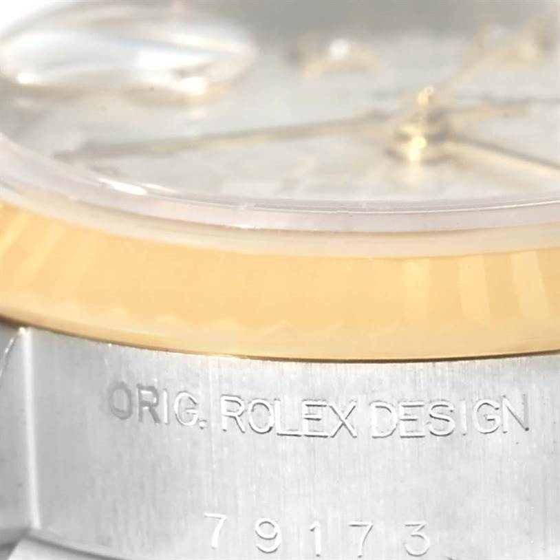 Close-up of the Rolex Datejust 79173 Women's Stainless Steel Silver Dial 79173 Women's Stainless Steel Silver Dial watch, showing the bezel, part of the dial, and the engraved case with "ORIG. ROLEX DESIGN" and model number.