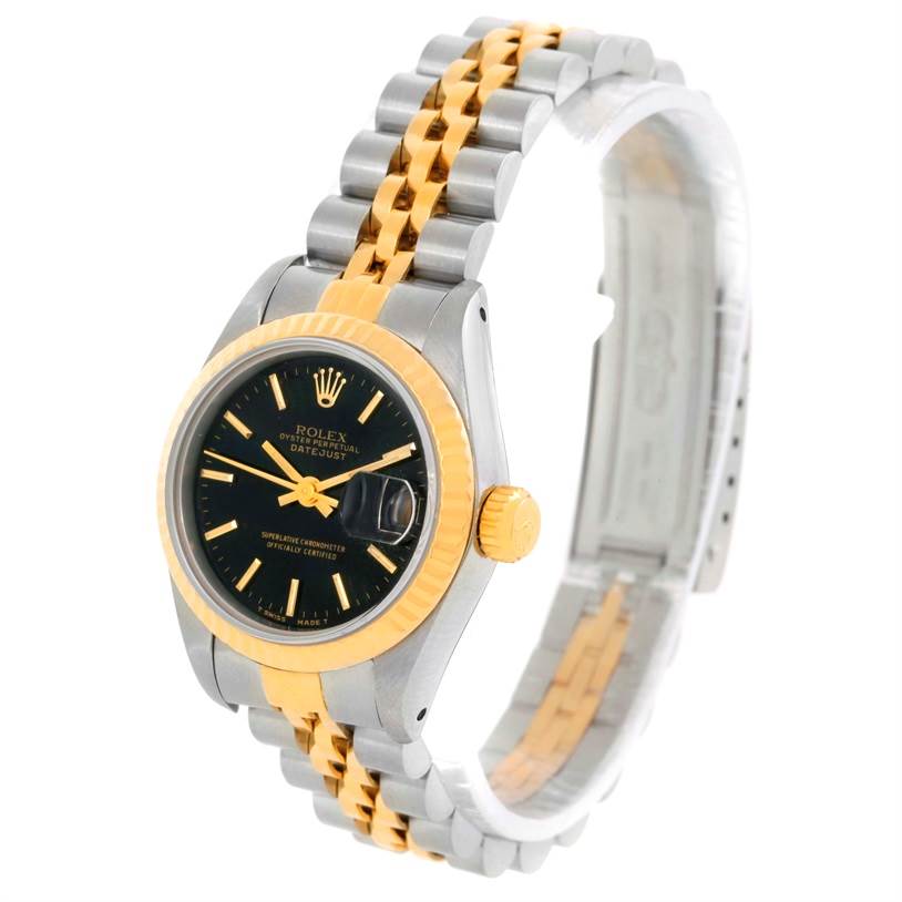 The image shows a Rolex Datejust 69173 Women's Stainless Steel Black Dial 69173 Women's Stainless Steel Black Dial watch at a slight side angle, highlighting its black dial, gold fluted bezel, and two-tone bracelet.