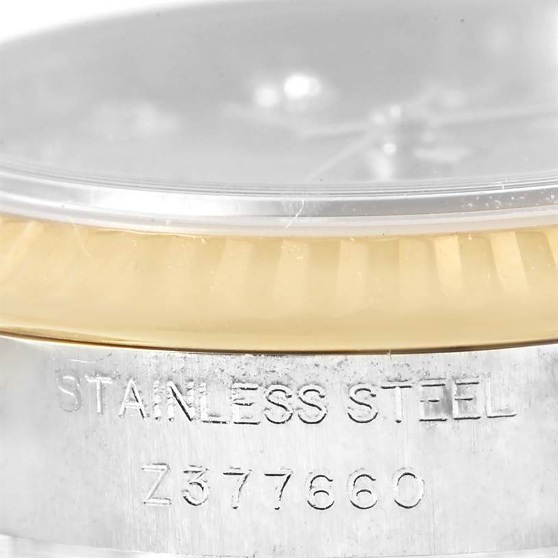 The image shows a close-up of the side of a Rolex Datejust 179173 Women's Steel and Gold (two tone) Champagne Dial 179173 Women's Steel and Gold (two tone) Champagne Dial watch, highlighting the stainless steel case and part of the bezel.