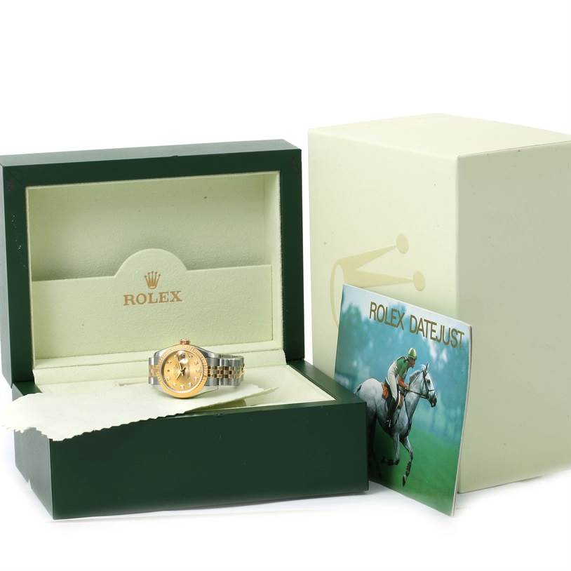 The image shows a Rolex Datejust 179173 Women's Steel and Gold (two tone) Champagne Dial 179173 Women's Steel and Gold (two tone) Champagne Dial watch inside its green box, along with an outer box and a pamphlet.