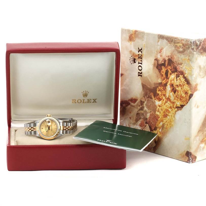 The Rolex Datejust 69173 Women's Stainless Steel Champagne Dial 69173 Women's Stainless Steel Champagne Dial watch is shown from a front angle in its box, along with accompanying documents and an outer box.