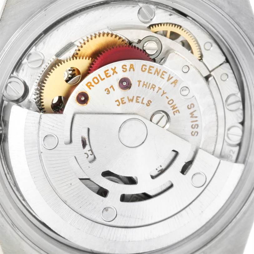 This image shows the internal mechanical movement of a Rolex Datejust 79173 Women's Steel and Gold (two tone) Mother of Pearl Dial 79173 Women's Steel and Gold (two tone) Mother of Pearl Dial watch, including gears and the rotor.