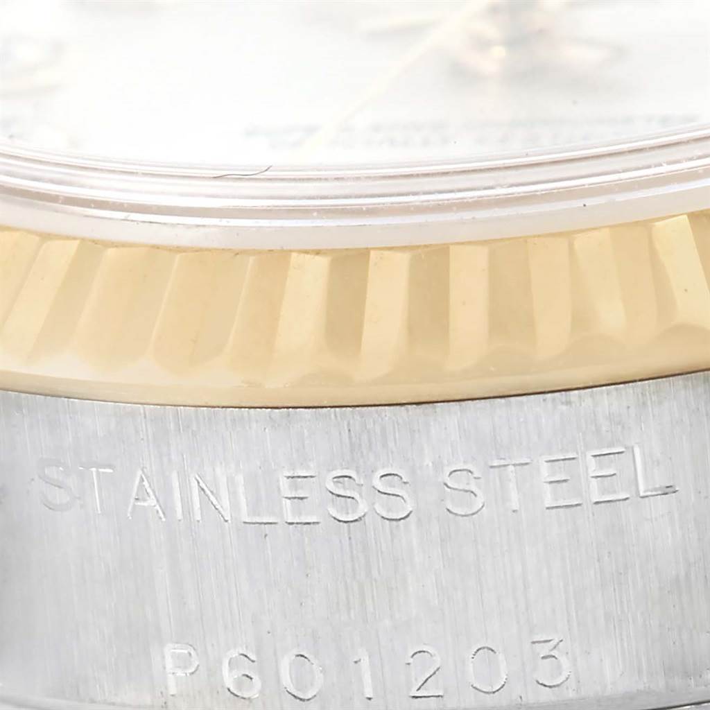 The image shows a close-up angle of the bezel and case side of the Rolex Datejust 79173 Women
s Stainless Steel Silver Dial 79173 Women
s Stainless Steel Silver Dial, highlighting its fluted design and engravings.