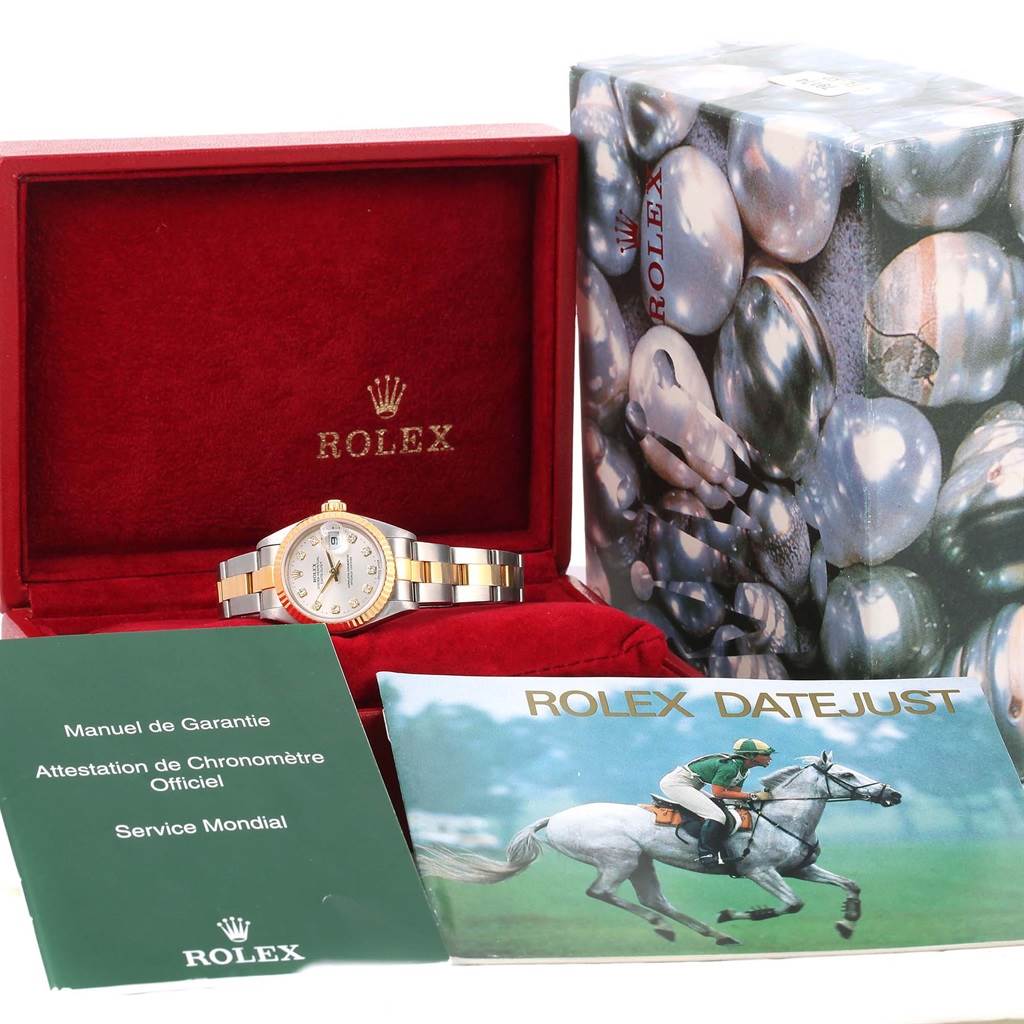 The Rolex Datejust 79173 Women
s Stainless Steel Silver Dial 79173 Women
s Stainless Steel Silver Dial watch is displayed in an open red box, with accompanying manuals and the outer packaging visible.