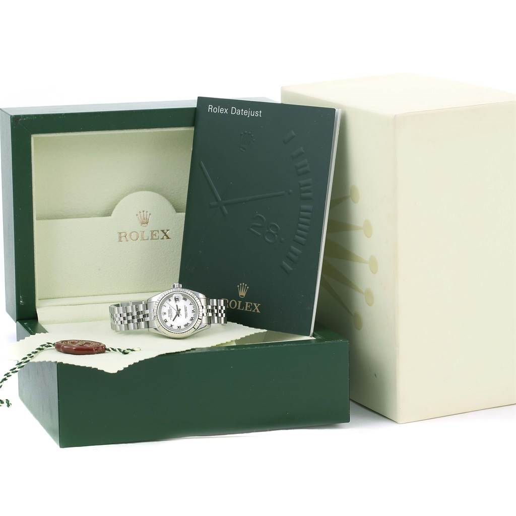 The image shows the Rolex Datejust 179174 Women's Stainless Steel White Dial 179174 Women's Stainless Steel White Dial watch at an angle inside an open green box, accompanied by a manual and original packaging.