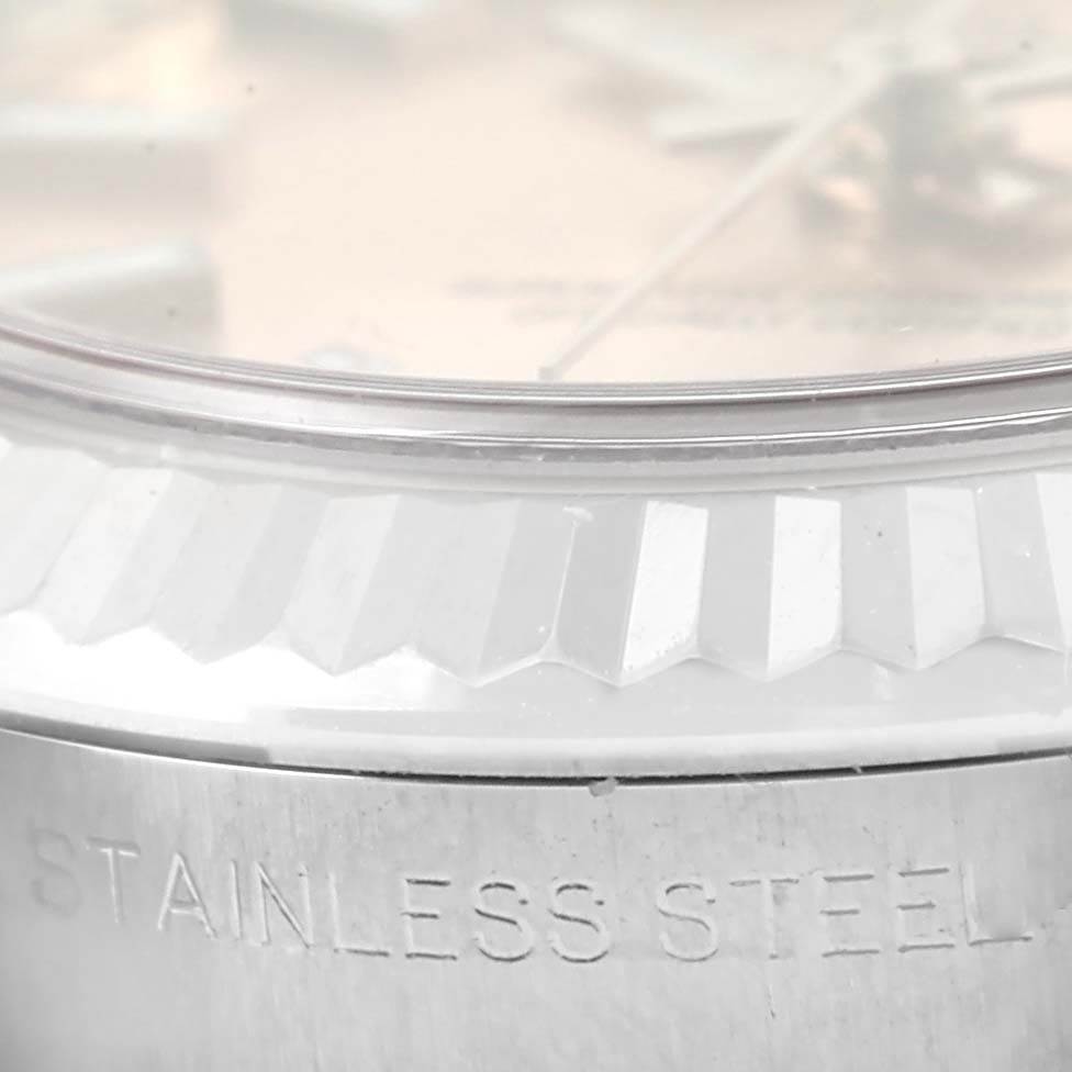 The image shows a close-up of the stainless steel case and fluted bezel of a Rolex Datejust 179174 Women's Stainless Steel Pink Dial 179174 Women's Stainless Steel Pink Dial watch.