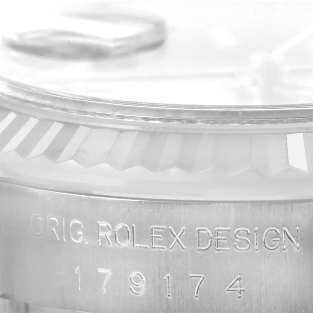 The image shows a close-up of the bezel and case side of a Rolex Datejust 179174 Women's Stainless Steel Pink Dial 179174 Women's Stainless Steel Pink Dial, highlighting the "ORIG. ROLEX DESIGN" engraving.