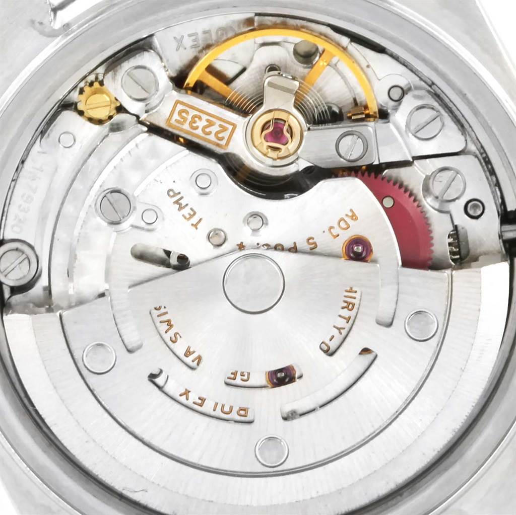 The image shows a close-up of the Rolex Datejust 79174 Women
s Stainless Steel Silver Dial 79174 Women
s Stainless Steel Silver Dial
s automatic movement and internal mechanism from a rear angle.