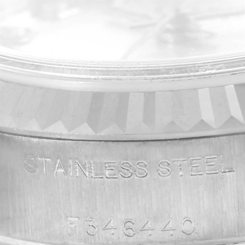 This image shows a close-up of the side of a Rolex Datejust 79174 Women
s Stainless Steel Silver Dial 79174 Women
s Stainless Steel Silver Dial watch, highlighting the bezel and inscription on the case.