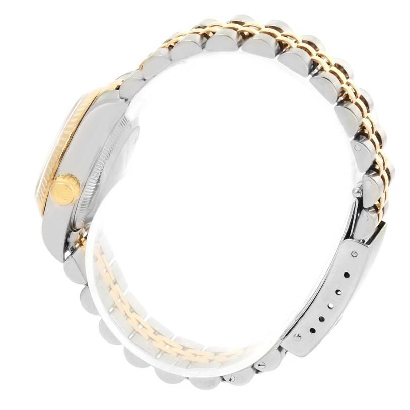 The image displays a side view of the Rolex Datejust 79173 Women
s Stainless Steel White Dial 79173 Women
s Stainless Steel White Dial watch, focusing on its gold and silver bracelet, clasp, and crown.