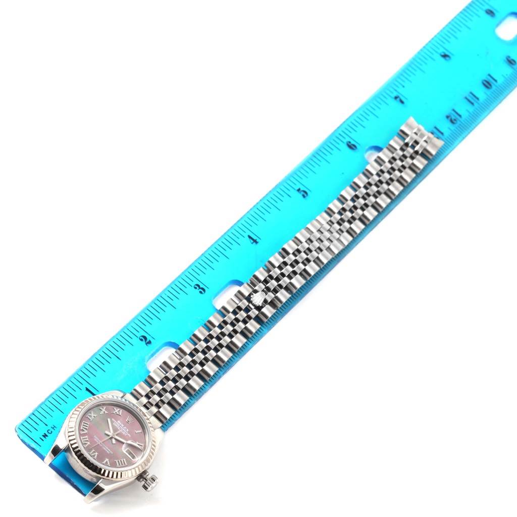 The Rolex Datejust 179174 Women
s Stainless Steel Mother of Pearl Dial 179174 Women
s Stainless Steel Mother of Pearl Dial watch is shown from an angled top view, displayed next to a ruler highlighting its band length.