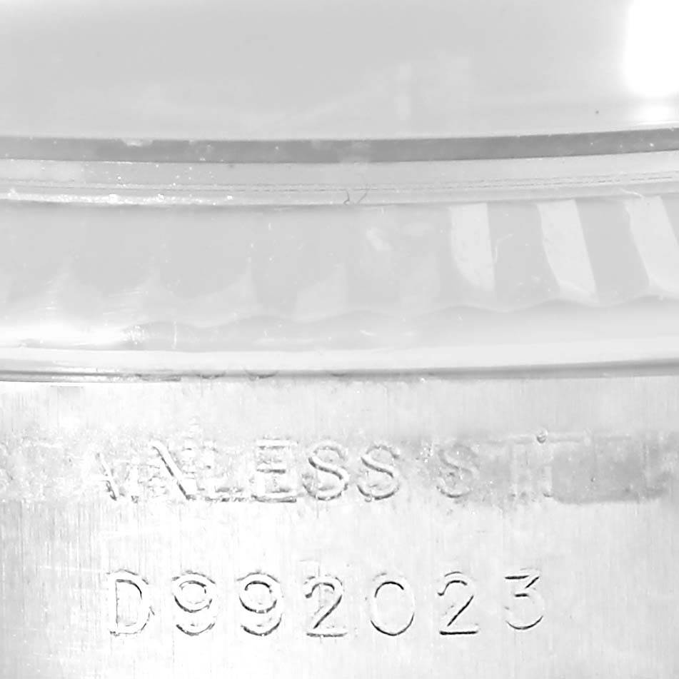 Close-up view of the engraved serial number and part of the bezel of a Rolex Datejust 179174 Women
s Stainless Steel Mother of Pearl Dial 179174 Women
s Stainless Steel Mother of Pearl Dial watch.