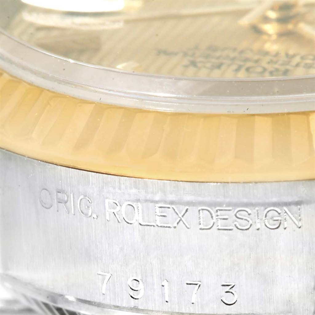 The image shows a close-up of the dial, bezel, and engraved case of a Rolex Datejust 79173 Women
s Stainless Steel Champagne Dial 79173 Women
s Stainless Steel Champagne Dial watch.
