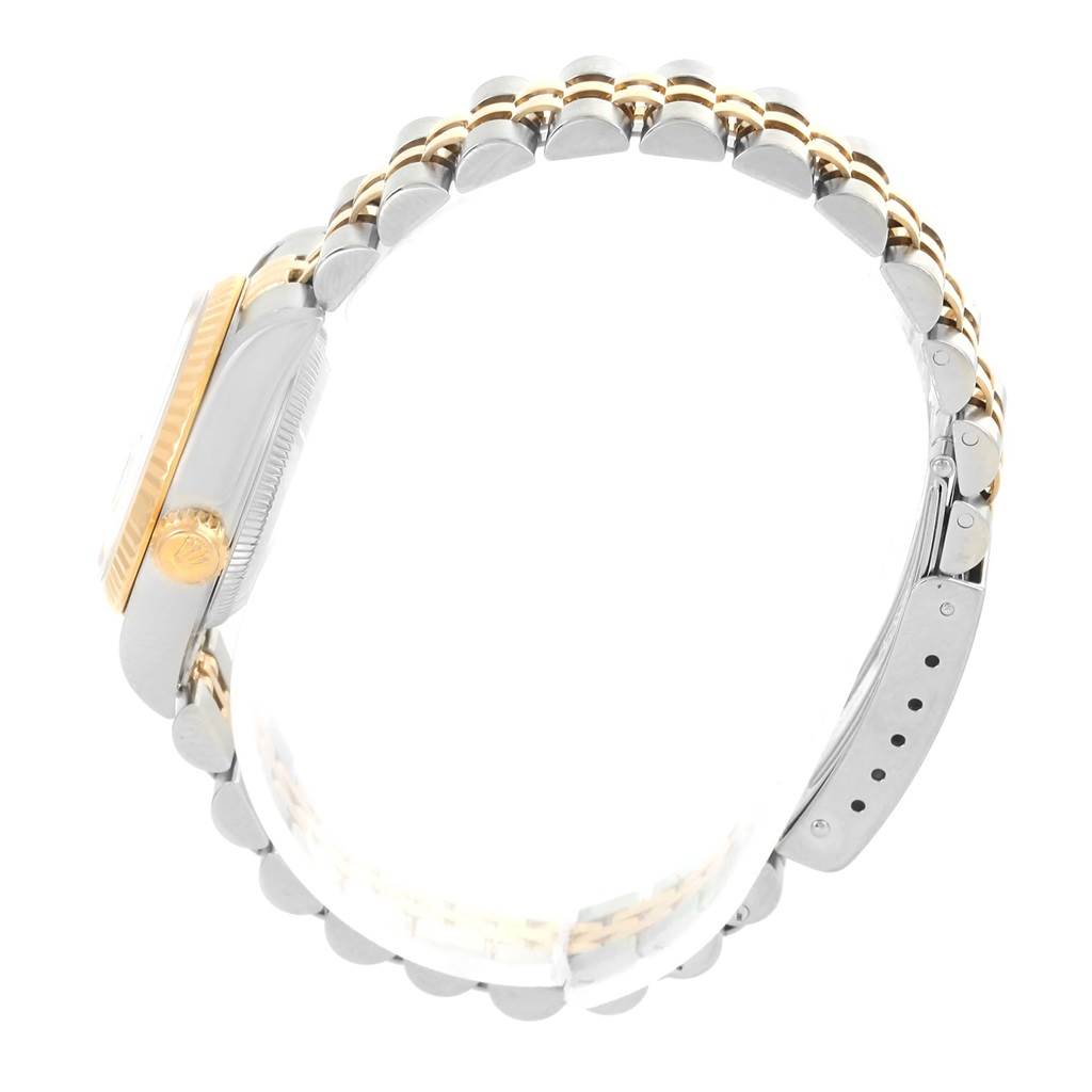 This image shows a side view of a Rolex Datejust 79173 Women
s Stainless Steel Champagne Dial 79173 Women
s Stainless Steel Champagne Dial watch, focusing on the case, crown, and part of the two-tone bracelet.