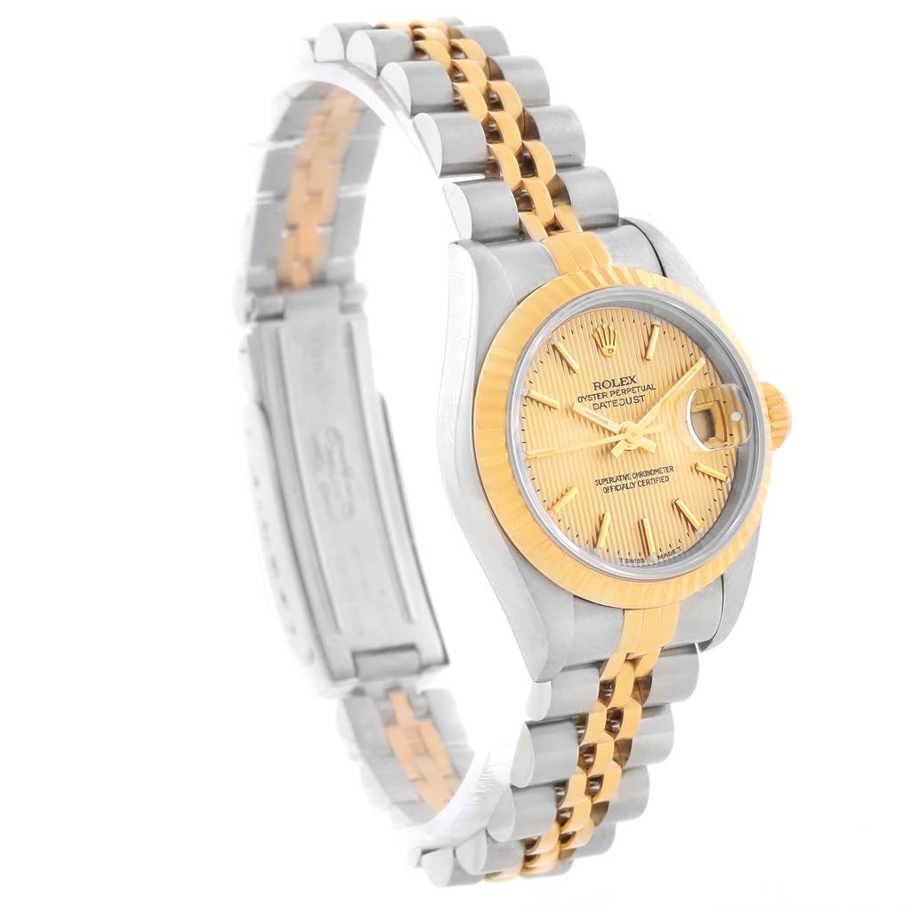 The image shows a side angle of a Rolex Datejust 79173 Women
s Stainless Steel Champagne Dial 79173 Women
s Stainless Steel Champagne Dial watch highlighting its dual-tone band, yellow dial, and fluted bezel.