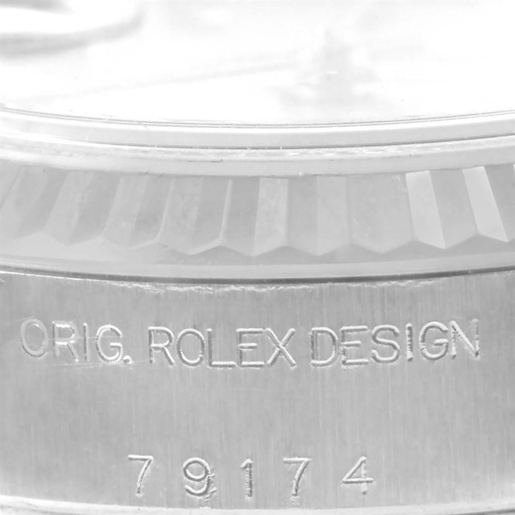 This is a close-up shot of the case and bezel of a Rolex Datejust 79174 Women's Stainless Steel Silver Dial 79174 Women's Stainless Steel Silver Dial, showing the inscription "ORIG. ROLEX DESIGN" and serial number "79174."