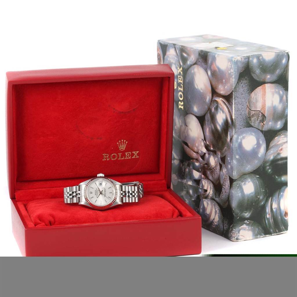 The Rolex Datejust 79174 Women's Stainless Steel Silver Dial 79174 Women's Stainless Steel Silver Dial watch is displayed front-facing in an open red box next to a decorative outer box.