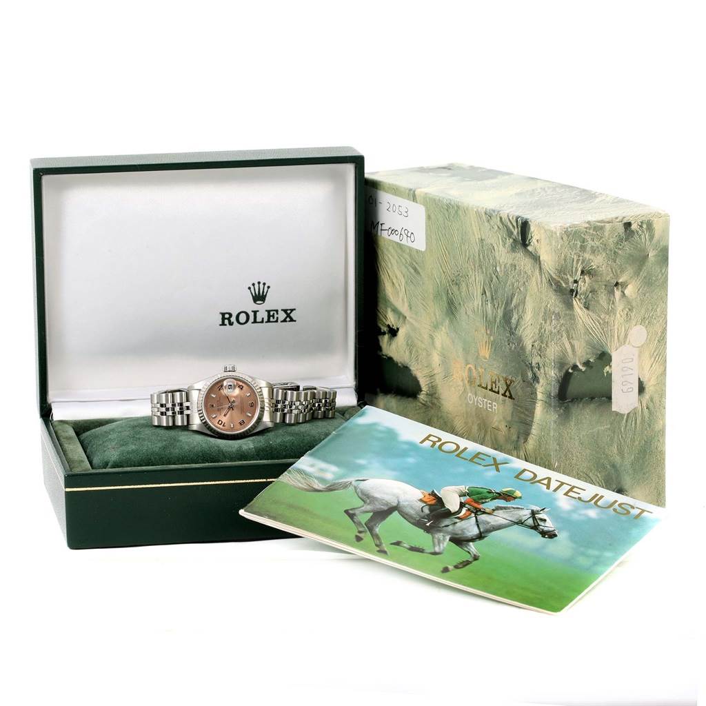 The image shows a Rolex Datejust 69174 Women's Stainless Steel Pink Dial 69174 Women's Stainless Steel Pink Dial watch in its box with its booklet and outer packaging, all viewed from the front.