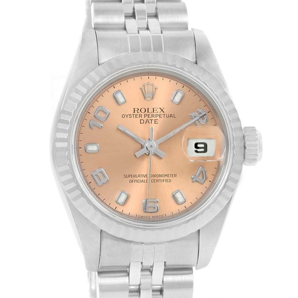 The image shows a frontal view of a Rolex Datejust 69174 Women's Stainless Steel Pink Dial 69174 Women's Stainless Steel Pink Dial watch, highlighting its peach dial, fluted bezel, and date display at 3 o'clock.