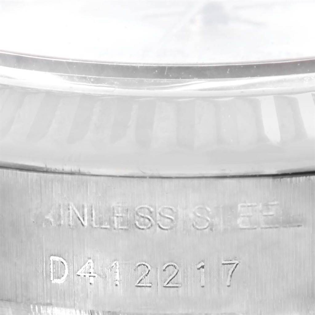 This image shows a close-up of the serial number and "STAINLESS STEEL" engraving on a Rolex Datejust 179174 Women
s Stainless Steel Mother of Pearl Dial 179174 Women
s Stainless Steel Mother of Pearl Dial watch case.